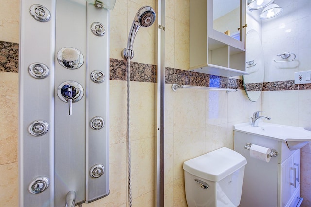 bathroom featuring toilet, tile walls, and vanity