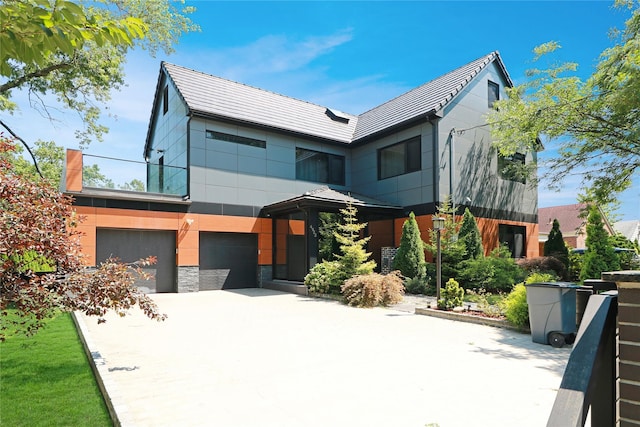 view of front facade featuring a garage, concrete driveway, and stone siding