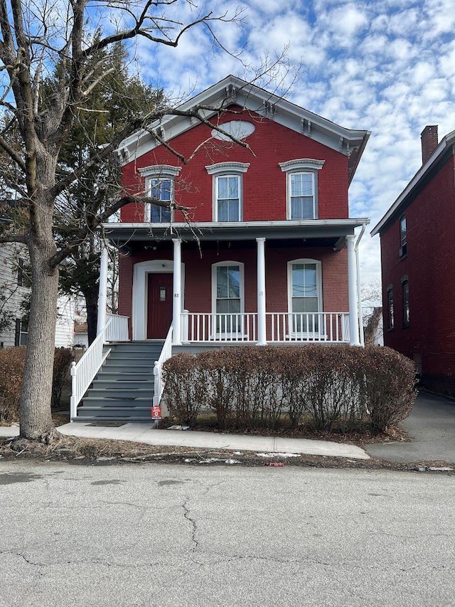 italianate house with covered porch and brick siding