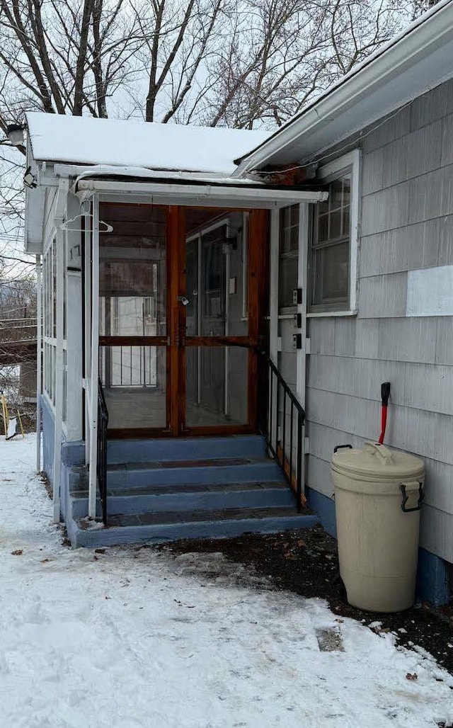 view of snow covered property entrance