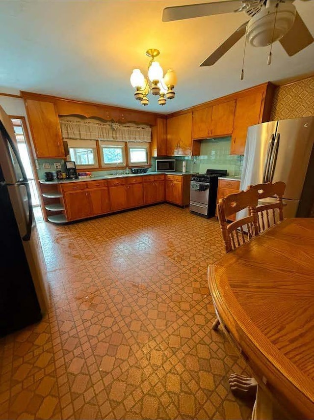 kitchen with a healthy amount of sunlight, appliances with stainless steel finishes, brown cabinets, and backsplash