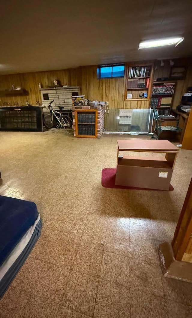 playroom with wooden walls and tile patterned floors