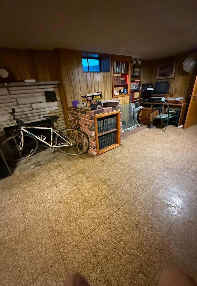 living area featuring wooden walls and tile patterned floors