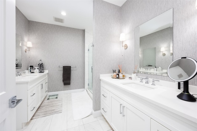 bathroom featuring visible vents, a sink, and wallpapered walls