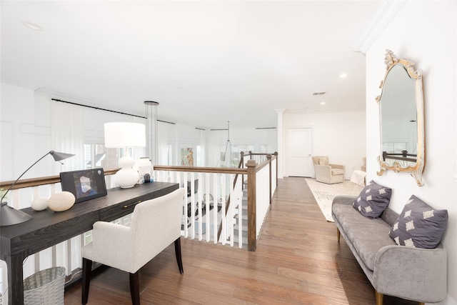 interior space with visible vents, ornamental molding, wood finished floors, and recessed lighting