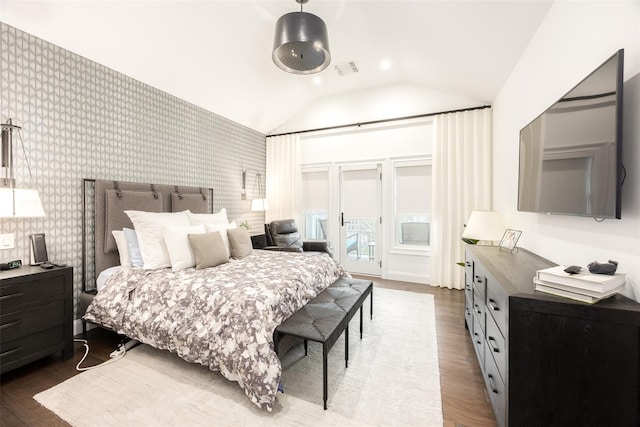 bedroom with lofted ceiling, wood finished floors, visible vents, access to exterior, and wallpapered walls