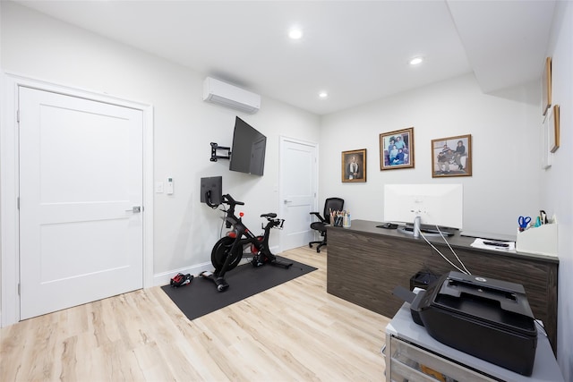 exercise area featuring baseboards, light wood finished floors, a wall mounted air conditioner, and recessed lighting