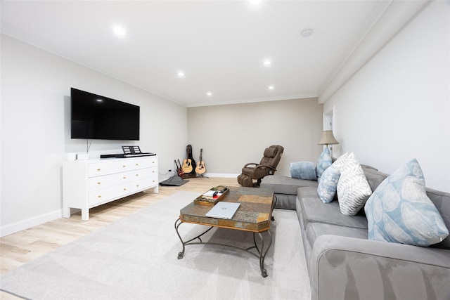 living area with baseboards, light wood finished floors, ornamental molding, and recessed lighting