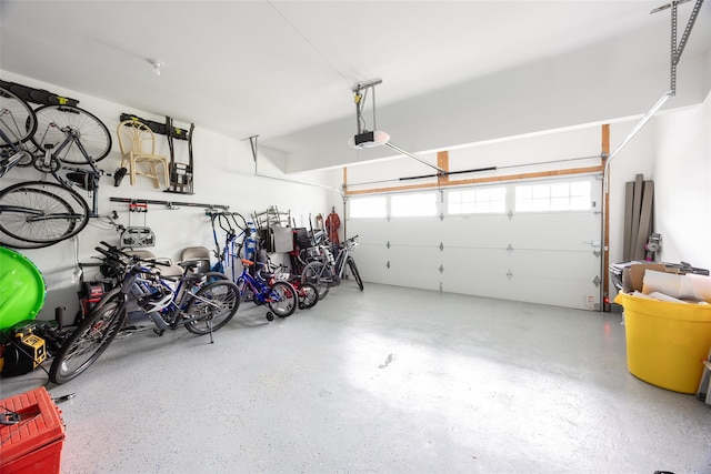 garage with a garage door opener and bike storage