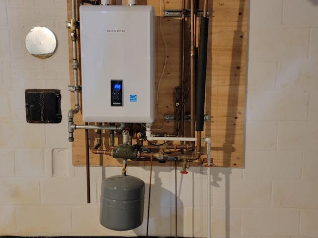 utility room featuring water heater