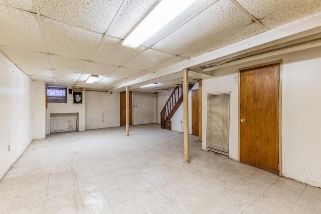 5130 47th St, Woodside, NY 11377 - finished below grade area featuring tile patterned floors, stairway, and a paneled ceiling