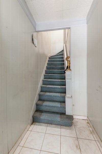 5130 47th St, Woodside, NY 11377 - stairway with tile patterned flooring, wood walls, and ornamental molding