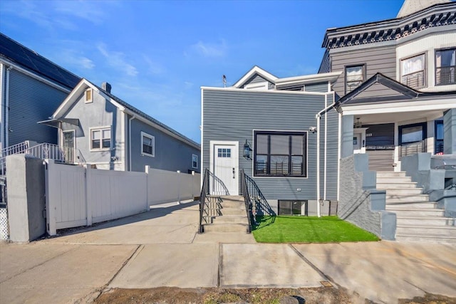 view of front of house featuring entry steps, a patio area, and fence