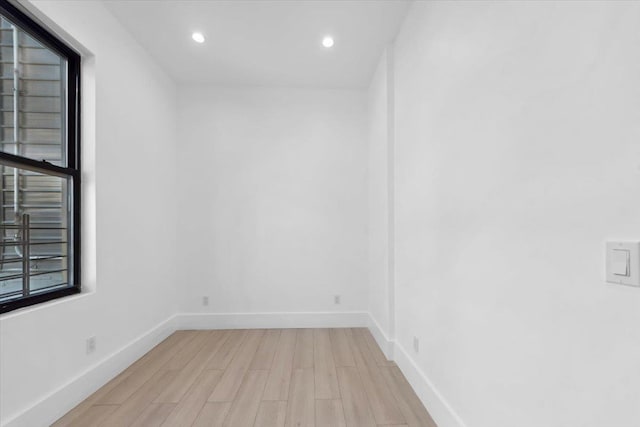 unfurnished room with light wood-style floors, baseboards, and recessed lighting