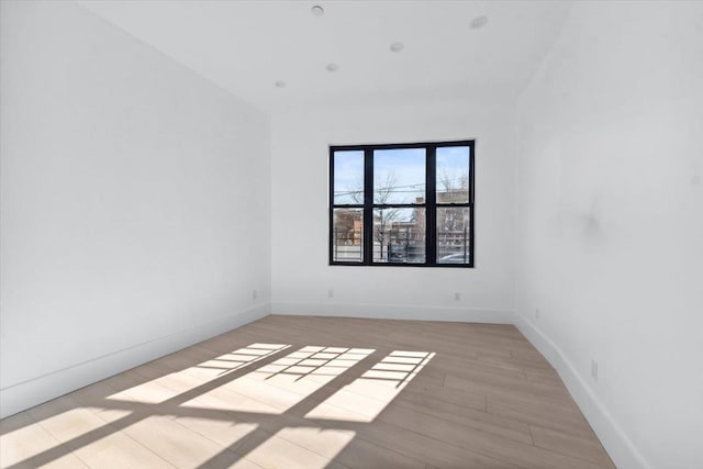 unfurnished room featuring light wood-style floors and baseboards