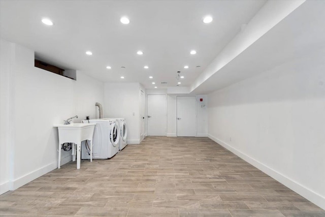 washroom featuring washer and clothes dryer, recessed lighting, light wood-style flooring, laundry area, and baseboards