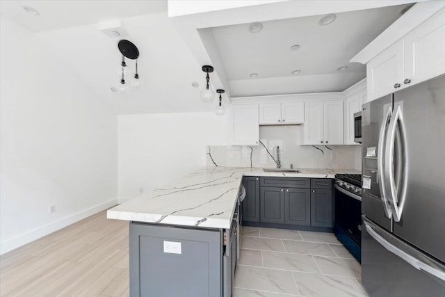 kitchen featuring a sink, gray cabinets, stainless steel appliances, white cabinetry, and backsplash