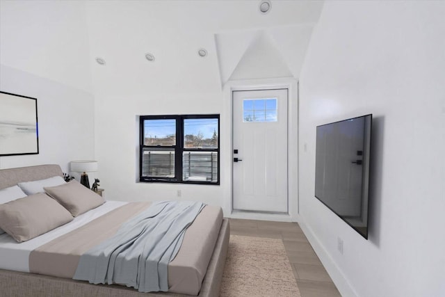 953 Tilden St, Bronx, NY 10469 - bedroom featuring baseboards, lofted ceiling, and light wood-style floors