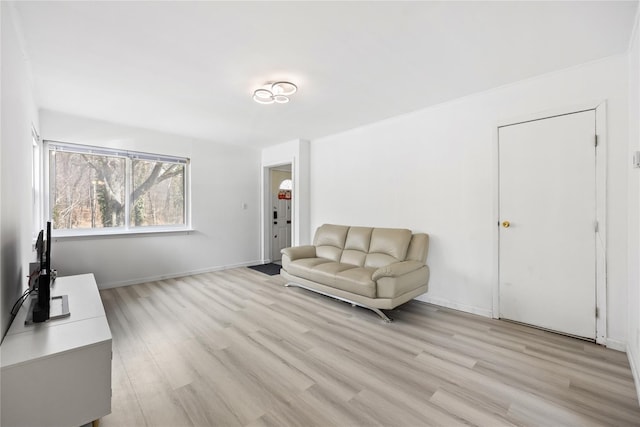 interior space featuring light wood-type flooring and baseboards