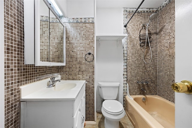 full bathroom with shower / bath combination, vanity, toilet, and tile walls