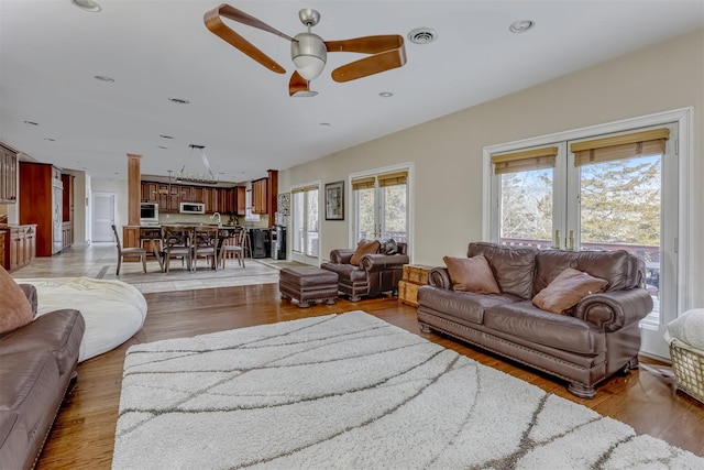 living area featuring light wood-style flooring, visible vents, recessed lighting, and ceiling fan