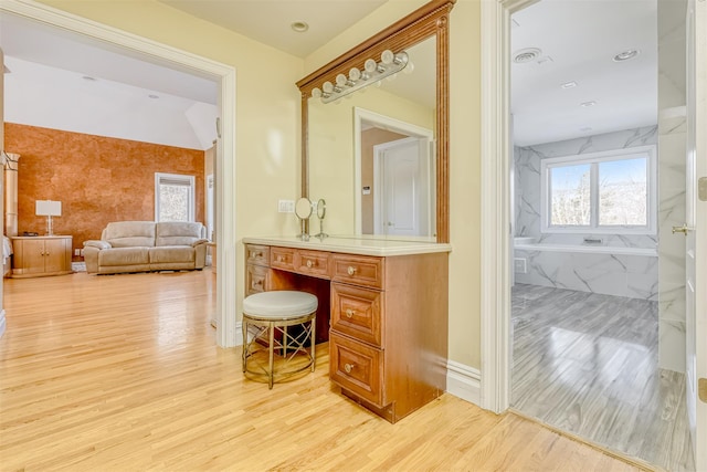 full bath with visible vents, baseboards, wood finished floors, and vanity