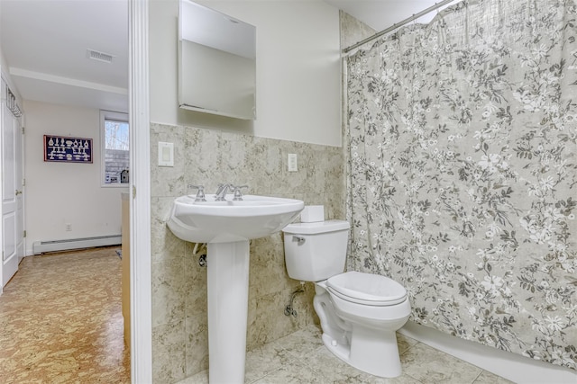 full bath featuring a baseboard heating unit, a shower with curtain, toilet, tile walls, and visible vents