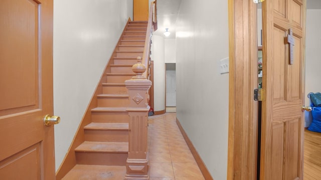 stairs with tile patterned flooring and baseboards