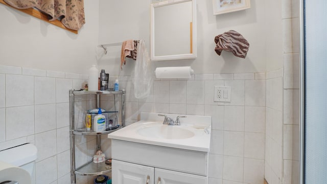 full bath with toilet, an enclosed shower, tile walls, and vanity