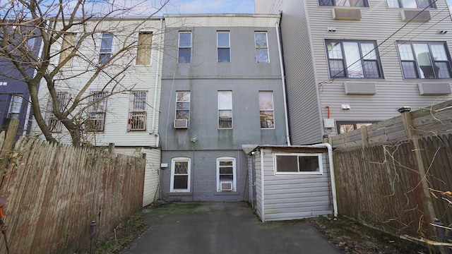 back of property featuring a patio area, fence, cooling unit, and stucco siding