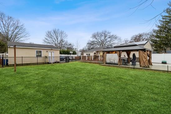 view of yard with a gazebo and a fenced backyard