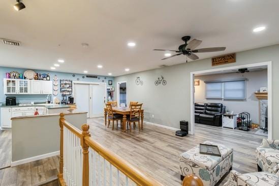 dining area featuring light wood-style floors, baseboards, visible vents, and recessed lighting