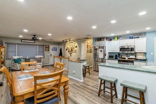 dining room with a toaster, recessed lighting, a ceiling fan, light wood-type flooring, and baseboards