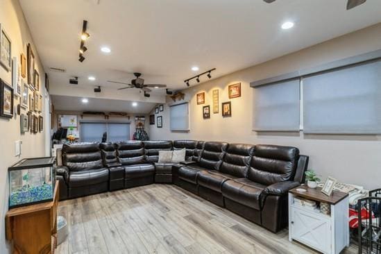 living area with light wood-style floors, track lighting, a ceiling fan, and recessed lighting