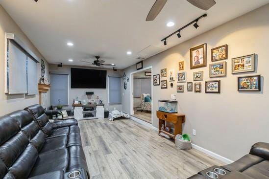 living room with recessed lighting, ceiling fan, track lighting, light wood-type flooring, and baseboards