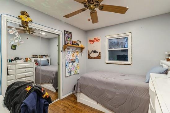 bedroom with baseboards, a closet, a ceiling fan, and wood finished floors