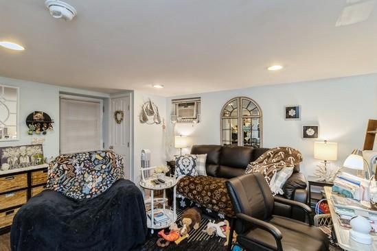 living room featuring recessed lighting and a wall mounted AC