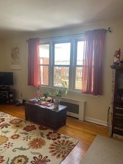 living area featuring light wood-style flooring and baseboards