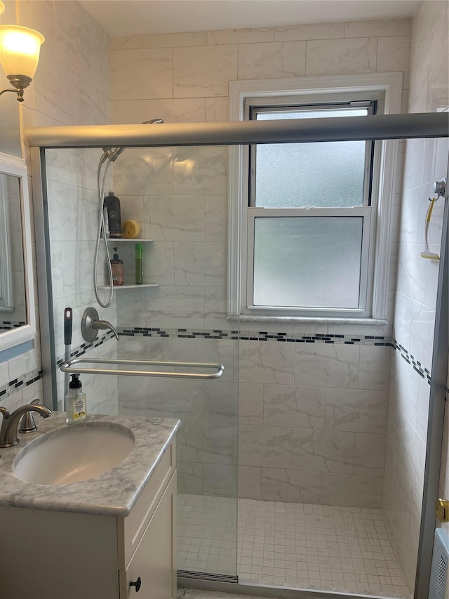 bathroom featuring a shower stall and vanity