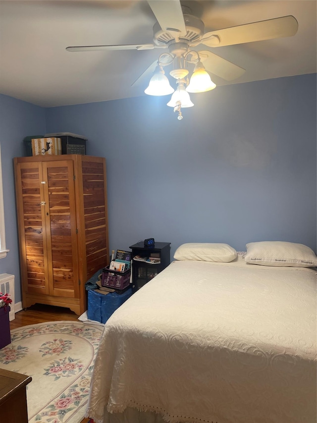 bedroom with a ceiling fan and wood finished floors