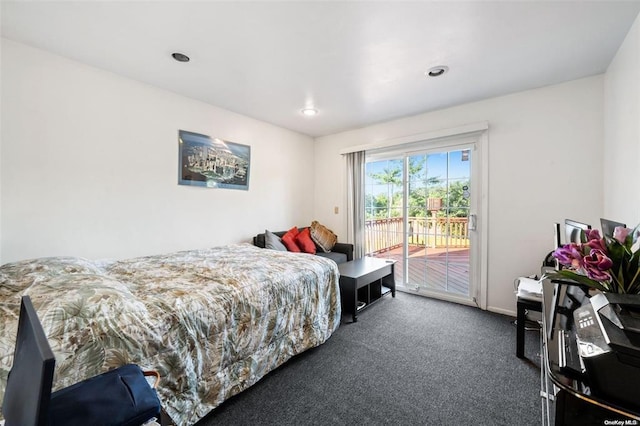 bedroom with dark carpet and access to exterior