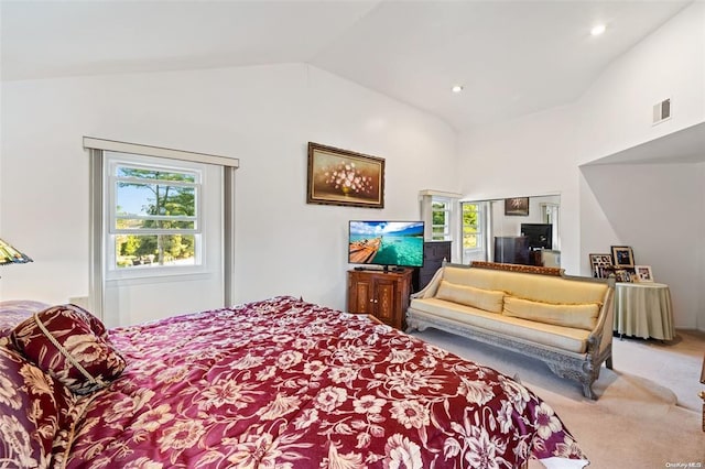 bedroom with lofted ceiling, multiple windows, carpet, and visible vents