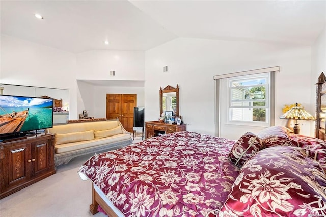 bedroom with high vaulted ceiling, visible vents, and light colored carpet