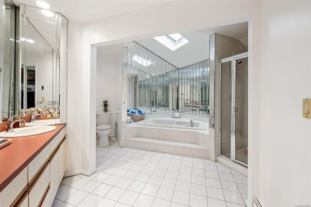 full bathroom featuring a skylight, toilet, a shower stall, vanity, and tile patterned floors