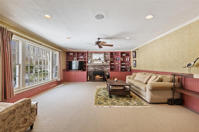 living room featuring carpet floors, a brick fireplace, crown molding, and recessed lighting