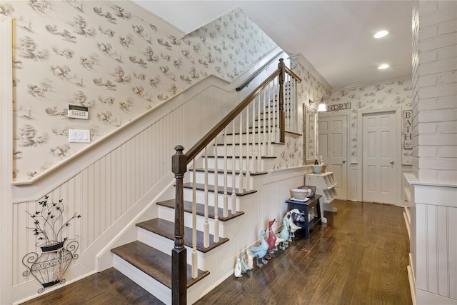 stairway featuring a wainscoted wall, recessed lighting, ornamental molding, wood finished floors, and wallpapered walls