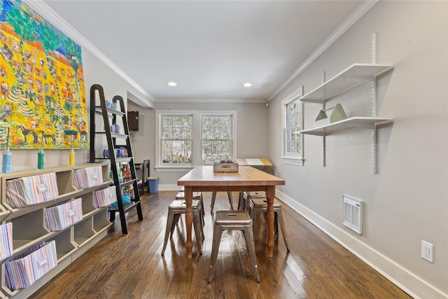 dining space with baseboards, dark wood finished floors, and crown molding