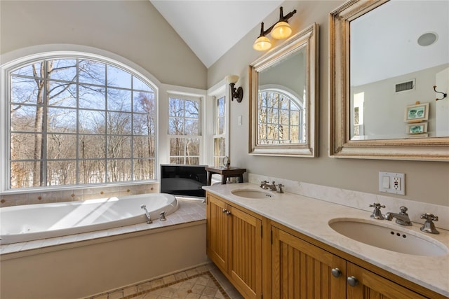 full bathroom with lofted ceiling, visible vents, a sink, and a bath