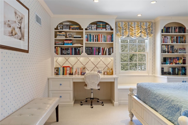 bedroom with light carpet, visible vents, wallpapered walls, built in desk, and crown molding