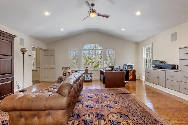 home office featuring lofted ceiling, light wood finished floors, visible vents, and a ceiling fan